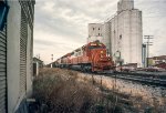 IC 6010 SD40A and GMO 910 SD40 lead another IC SD40A with a coal train past the Tuscola Coop Grain elevator